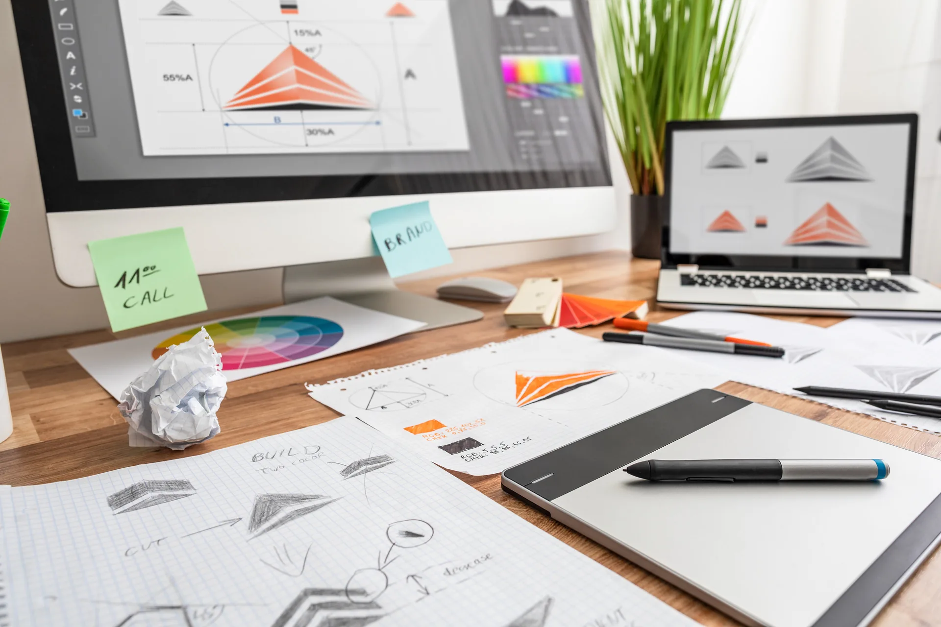 Graphic designer sketching logo designs at workstation